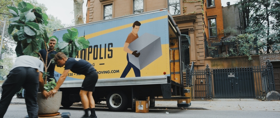 Moving van with people moving a plant
