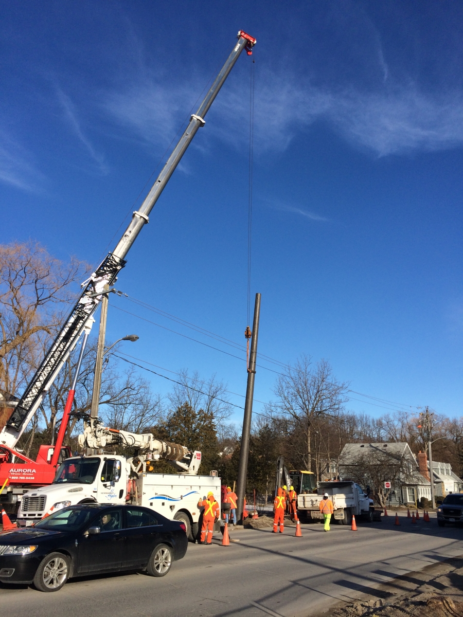 Construction workers installing a electrical pole