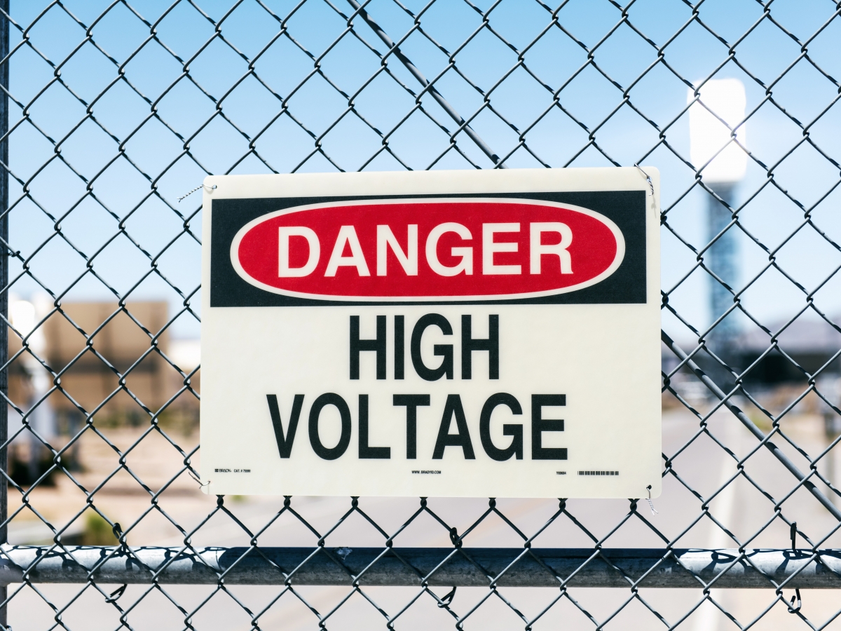 Danger High voltage sign on a fence