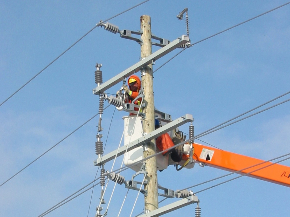 Worker is working on an electrical line in the sky