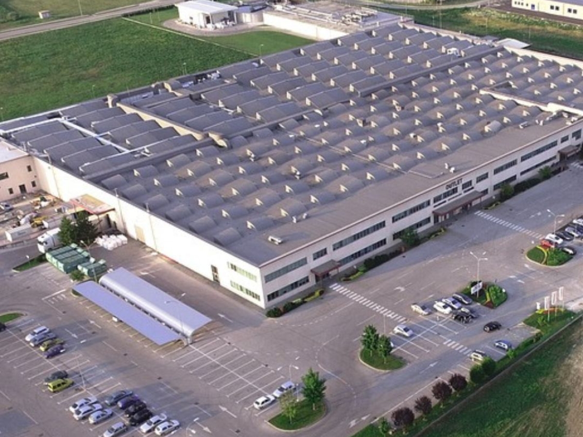 The image depicts an aerial view of a large industrial building